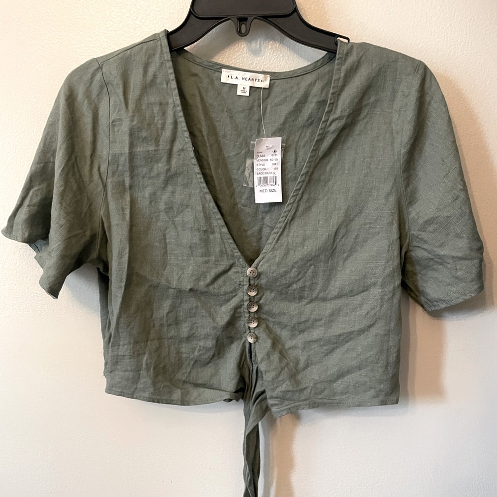 Sage green crop top with tie in front.